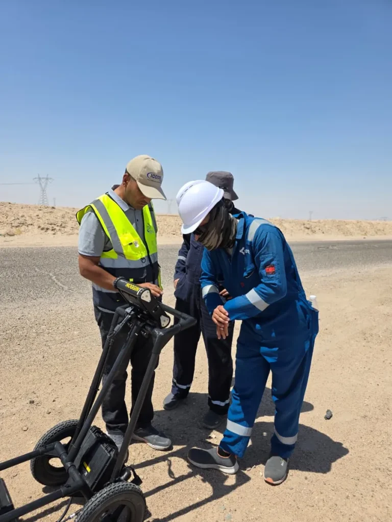 Instructor and oil company staff reviewing readings on the Noggin GPR cart at the roadside