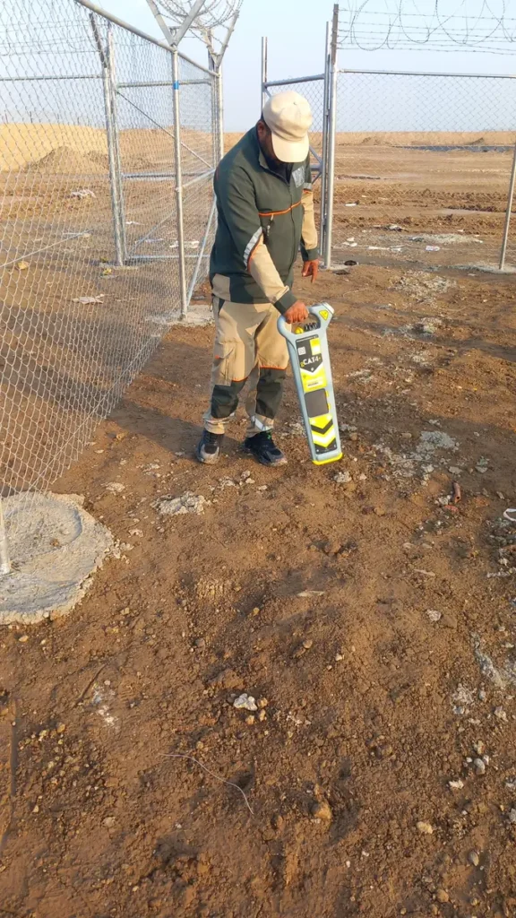 Trainee sweeping for buried services with the gCAT4 inside the facility perimeter