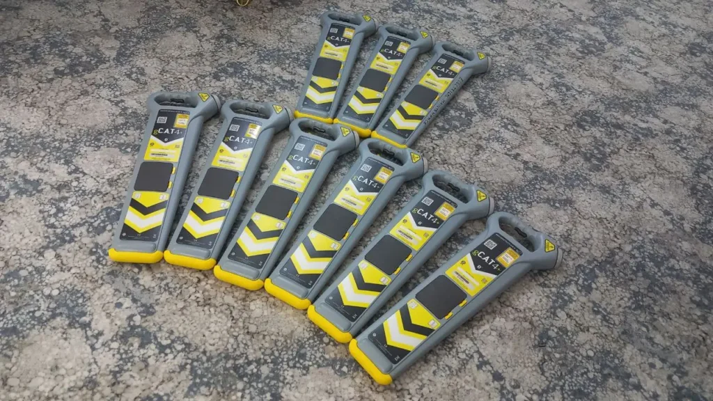 Nine Radiodetection gCAT+4 utility locators laid out for testing and calibration