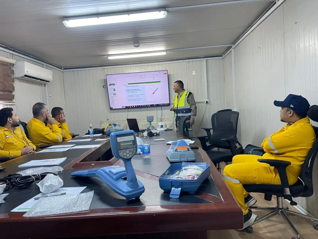 Electromagnetic theory session during the RD8200G course at an oil field facility, with the locator and transmitter on the table