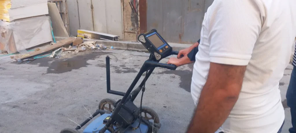 Trainee running the GPR cart across a survey line during the course