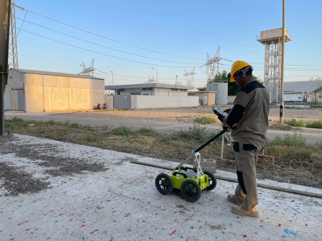 Running the 800 MHz GPR antenna across the marked concrete slab