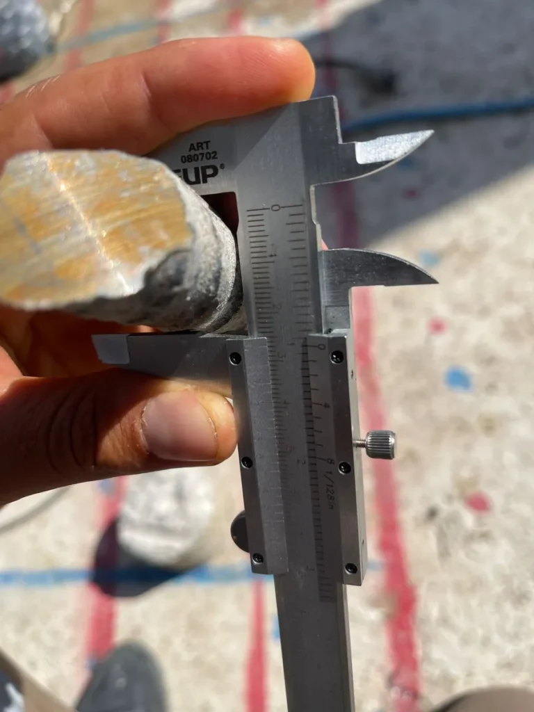 Measuring the diameter of reinforcement recovered from a core with a vernier caliper